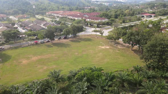 Aerial view of football field and roundabout in Desa Pinggiran Putra