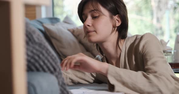 Melancholy Young Woman Lying on the Couch Feeling Depression and Stress