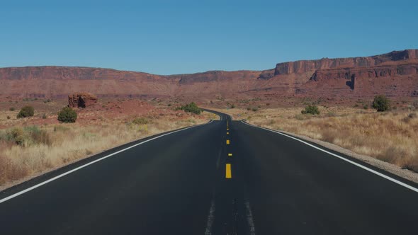 Motion On An Empty Country Road Going Into The Distance To Red Mountain Rocks alt