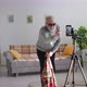 Modern Hobby of Pensioner Grandfather Wearing Glasses Shows Trick with Disappearing on Mobile Phone - VideoHive Item for Sale