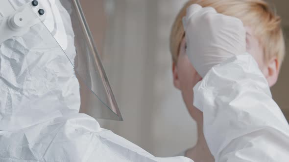 Doctor Scientist Medical Worker in Protective Uniform Transparent Face Shield Latex Gloves Uses alt