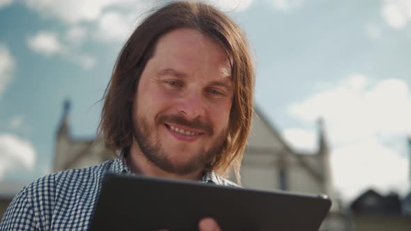 Young Handsome Fashion Model Businessmen Using Tablet Outdoors, Man Male Portrait with Tablet alt