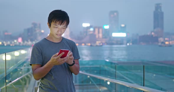 Man use of mobile phone in city alt