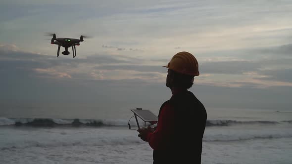 Male engineer doing inspection using drone - Technology and industrial concept alt