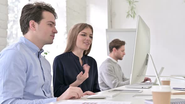 Attractive Startup Team Doing Video Chat on Desktop in Office alt