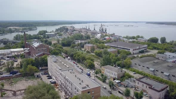 Aerial View of Industrial Area of City in Summer Day, Near River , Cars Are Moving