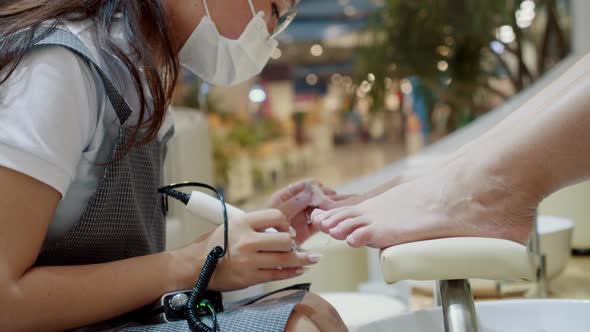 Beautician Carries Out Procedureprepares and Processes Client's Nail with a Special Device with a alt