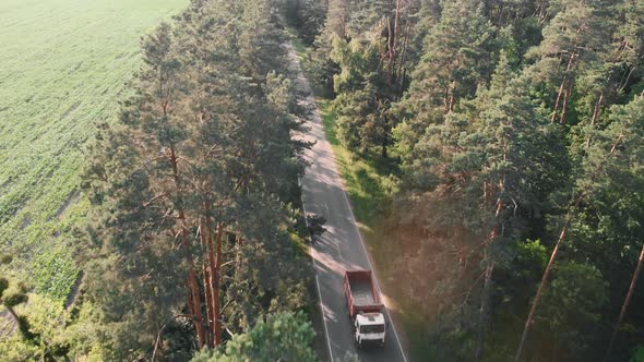 Car overtaking cyclist, aerial drone view alt