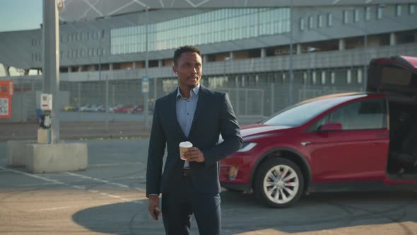 Handsome African Man in Business Suit Drinking Fresh Coffee While Waiting for alt
