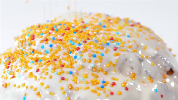 Confetti Is Sprinkles on Top of Easter Cake with White Glaze, Close-up.