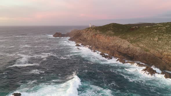 Amazing drone aerial sea landscape view of Cape Tourinan Lighthouse, in Spain at sunset alt