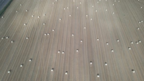 Aerial View Of Large Farm Land With Round Hay Bales For Animal Livestock Near Portlaoise Town In Dun alt