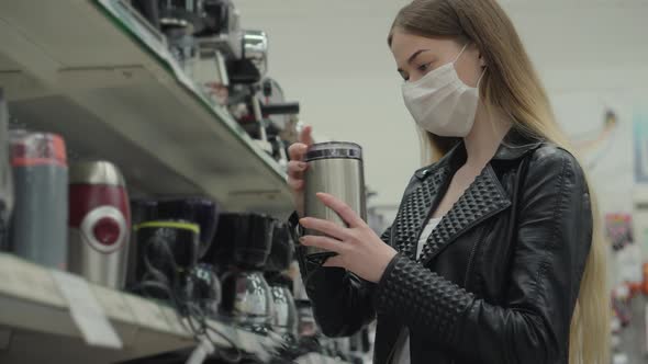 Woman Buying Coffee Grinder in the Hypermarket alt