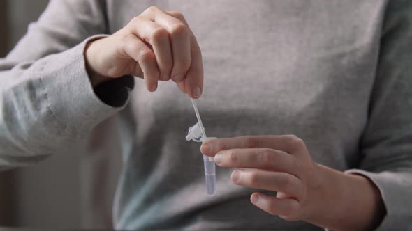 Woman Making Self Testing Coronavirus Test at Home
