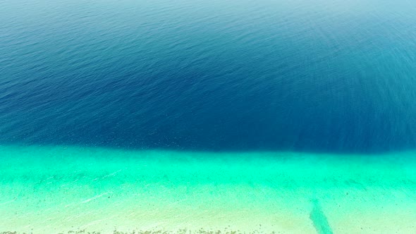 Natural overhead island view of a white sand paradise beach and aqua blue water background in colorful alt