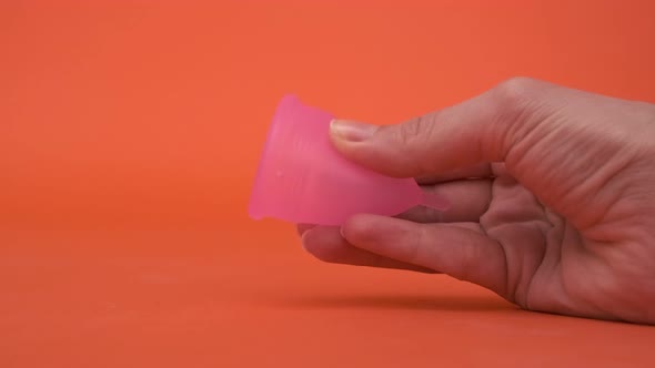 Pink Menstrual Cup Closeup on a Red Background