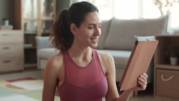 Fit Woman Video Calling Using Tablet alt