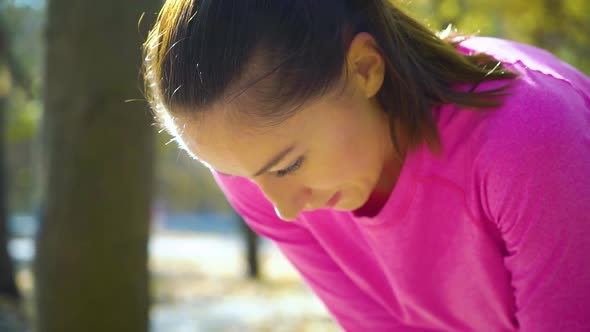 Jogger Girl Breathing Hard After Training in Sunny Park alt