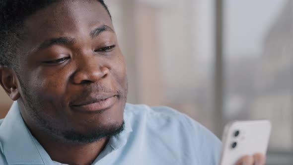 Smiling Happy African Man Businessman Adviser American Brunet Guy Expert Hold Mobile Phone Look at alt