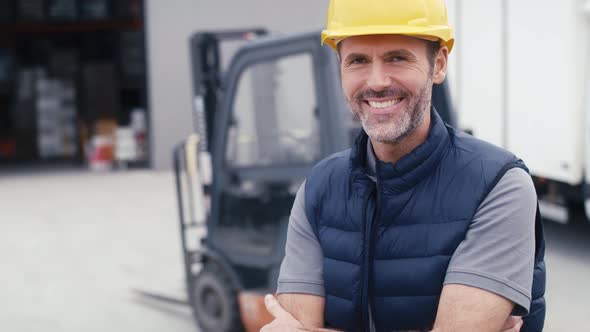 Portrait of caucasian mature man in front of warehouse. Shot with RED helium camera in 8K. alt