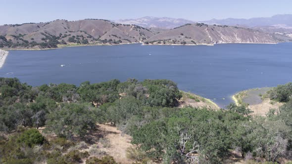 Aerial Drone Shot of a Trails Leading to a Lake and Dam (Cachuma Lake, California)