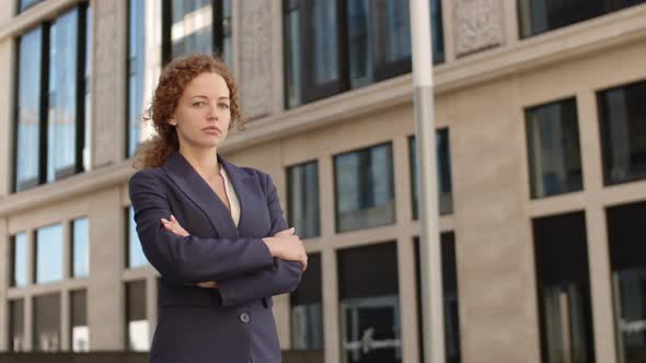Young Caucasian Businesswoman Standing Outside alt