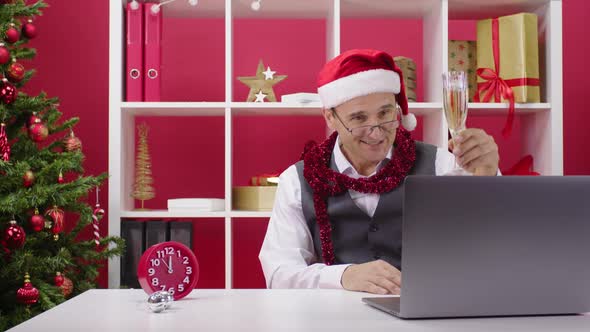 Corporate Employee Remotely Participates in Online Champagne Christmas Party