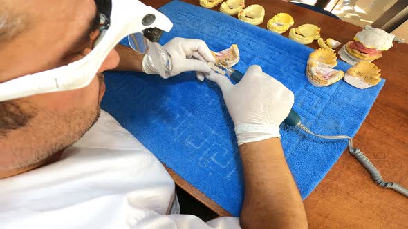 Dental Technician Polishing A Tooth