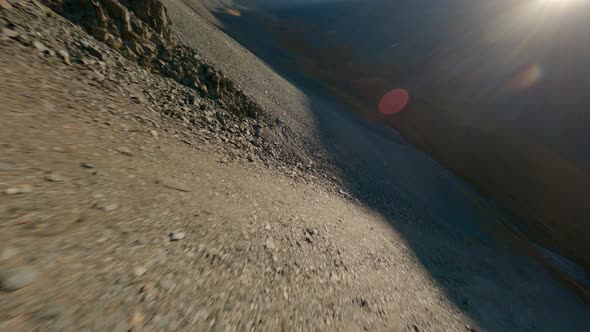 Aerial View Speed Dive Cliff Stone Structure Flying Mountain Ridge Sun Lights Glare Sunrise Sunset alt