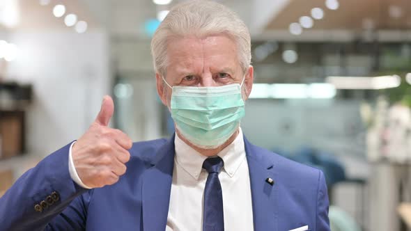 Senior Old Businessman with Face Mask Showing Thumbs Up  alt