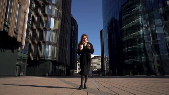 Young Business Woman With Coffee To Go Using Mobile Phone