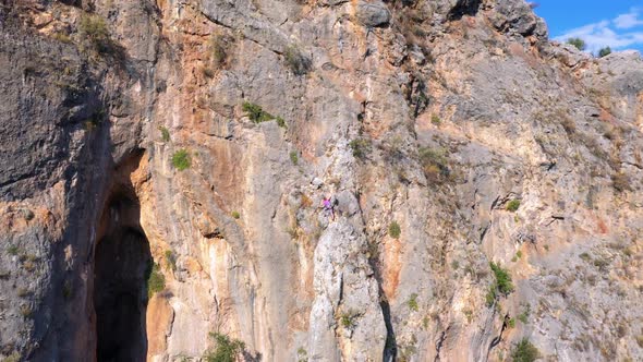 Rock Climbers Climbing on the Cliff alt