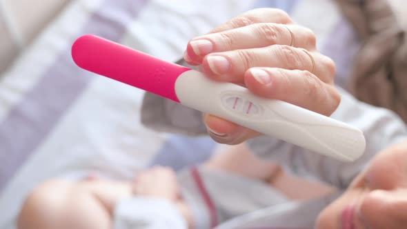 Woman with Pregnancy Test alt