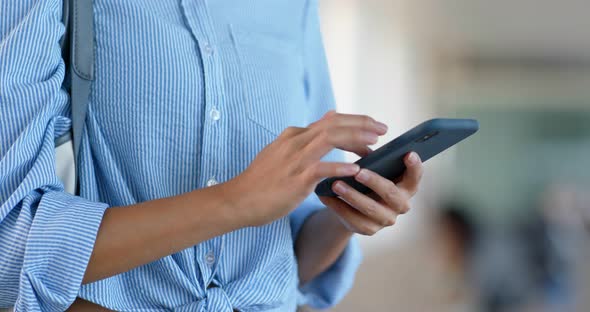 Woman use of smart phone at street alt