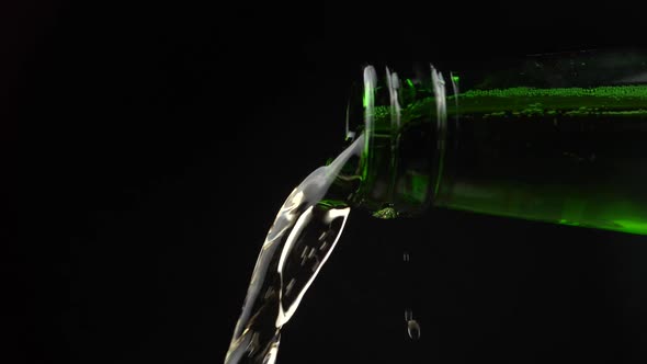 slow motion pouring from a beer bottle neck