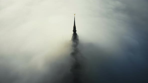 Atmospheric Aerial Shot, Thick Fog Clouds Flow Covering Famous Majestic Mont Saint Michel Fortress alt