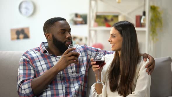 Young Couple Clinking Wine Glasses, Romantic Evening at Home, Togetherness alt
