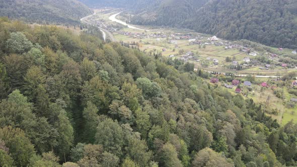 Village in the Carpathian Mountains in Autumn. Slow Motion, Aerial View alt