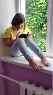 Girl schoolgirl plays smartphone game