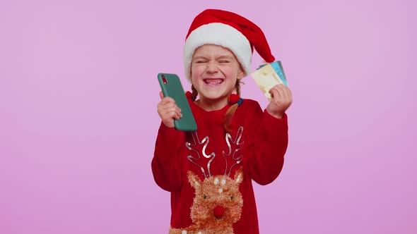 Child Girl in Christmas Sweateruse Mobile Cell Phone Plastic Credit Bank Cards Win Calebrate Wow alt