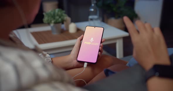 Asia lady wear headphones using phone listen digital music podcast online channel sit on sofa. alt