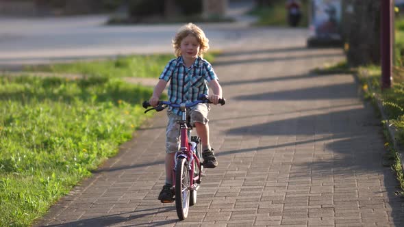 Blond Boy Riding on the Kids Bike