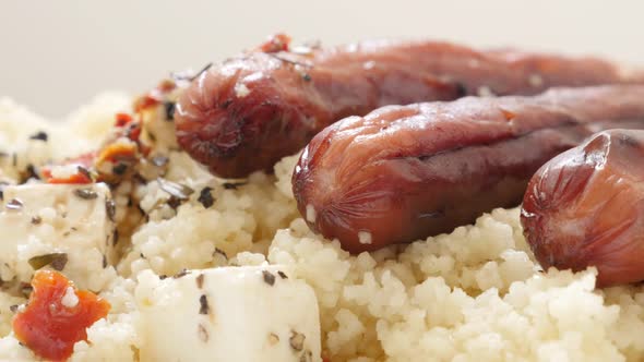 Cheese cubes and fried sausages with semolina steamed balls  4K 2160p 30fps UltraHD tilting footage  alt