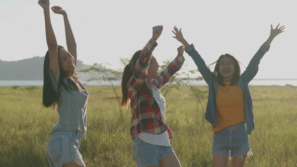 Asian women running while sunset having fun together a summer traveling.