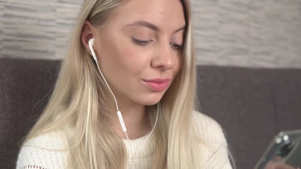 Positive girl enjoys listening music with headphones. alt