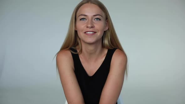 Portrait of Adorable Young Blonde European Woman Smiling Talking Looking at Camera Medium Shot