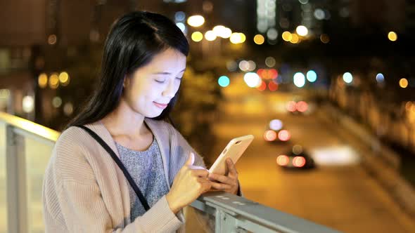 Woman using cellphone at night  alt
