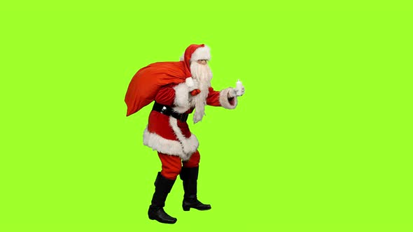 Santa Claus with Burning Candle Brings Christmas Gifts on Green Background