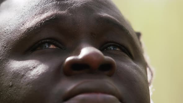 Black Lives Matter. Close Up Shot of African Man with Red Eyes Looking Up alt