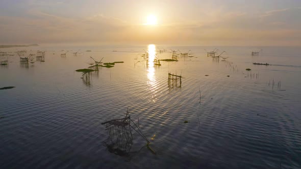Local fishing trap net in canel, lake or river at sunset. Nature landscape fisheries and fishing alt